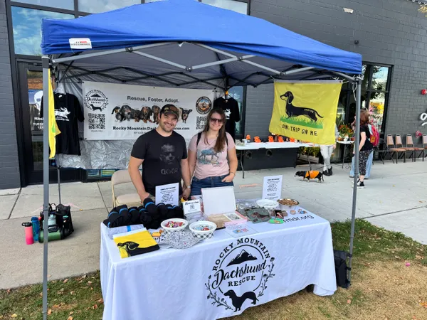 This is the Rocky Mountain Dachshund Rescue RMDRorg booth at the Maven District Street Fair in Salt Lake City Utah Our DONT TRIP ON ME flag was a huge hit People loved itWe have several more events coming up in October where well be selling the flags and hopefully well need to place another order soon Thanks for such a fun product Its been a great addition to our rescue booth