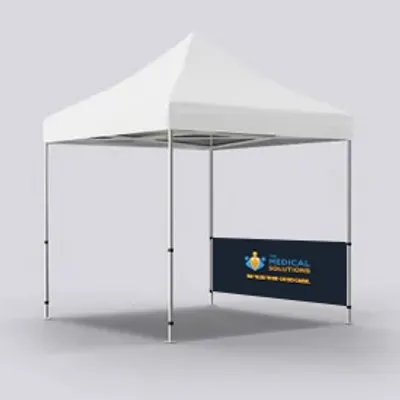 A white canopy tent with a custom printed back wall displaying a blue background, a medical logo, and text reading 'MEDICAL SOLUTIONS COMPANY' on a gray surface.